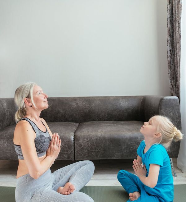 Child sitting calmly in a simple meditation pose.